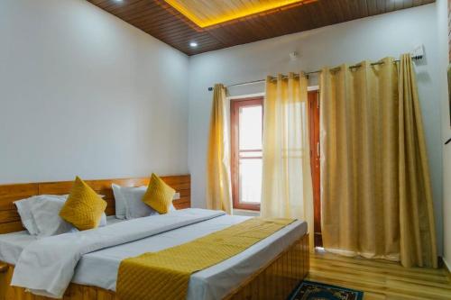 a bedroom with two beds and a window at Baatuli Homestay in Nainital