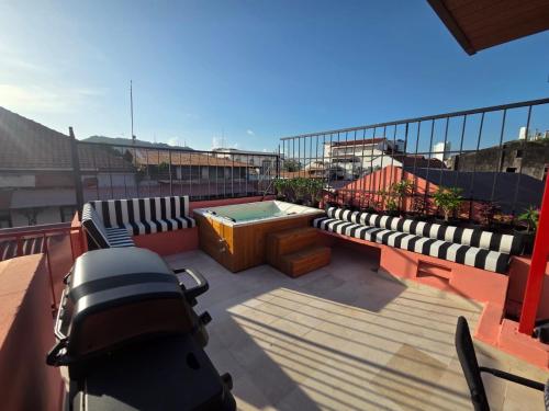 a balcony with a hot tub and benches on a building at Casa AcoModo at Casco Viejo 6BR Mansion w Pool in Panama City