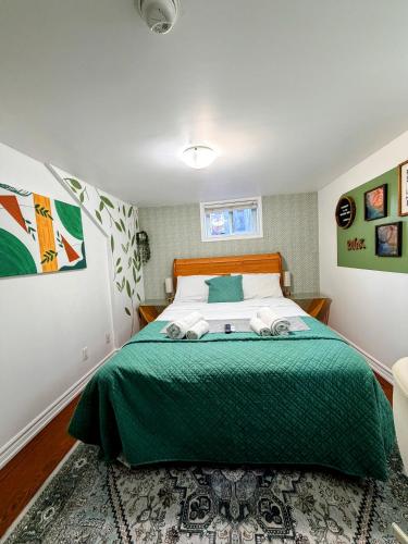 a bedroom with a bed with a green comforter at Private room near subway & shops in Toronto