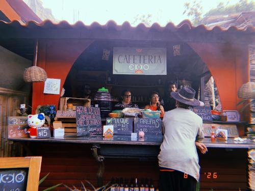 a man standing in front of a book store at Ekko Hostel in Tepoztlán