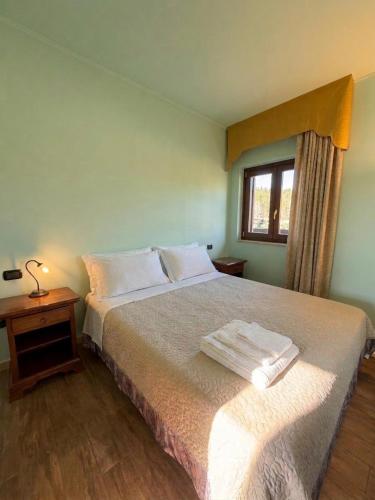 a bedroom with a bed with two towels on it at Agriturismo Montebeltrano in Paterno Calabro