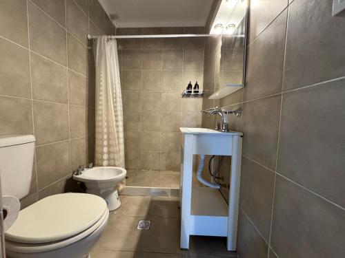 a small bathroom with a toilet and a sink at Las Golondrinas Mar del Plata in Mar del Plata