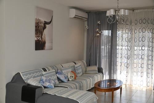 a living room with a couch and a table at 50 meters to the beach 3 bedroom appartment in Limassol