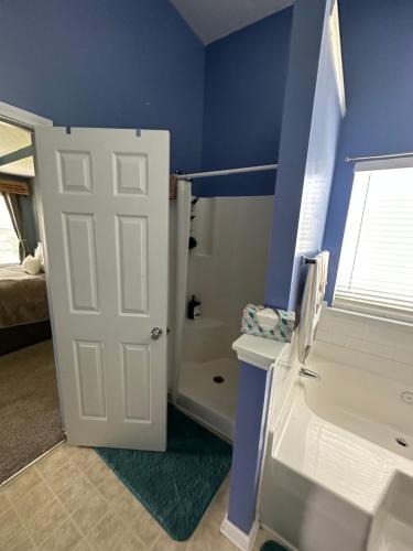 a room with a white door and a blue wall at Country house in Covington