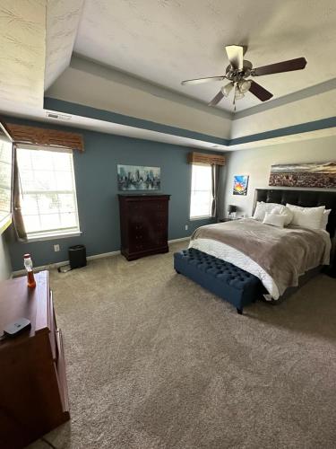 a bedroom with a bed and a ceiling fan at Country house in Covington