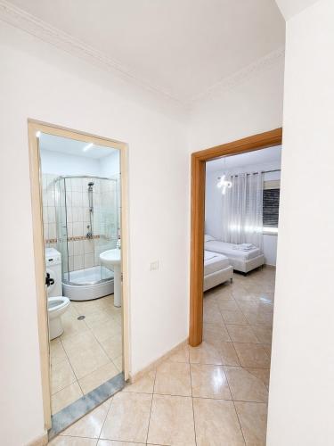 a bathroom with two sinks and two toilets at H&G Seaview Apartments in Durrës