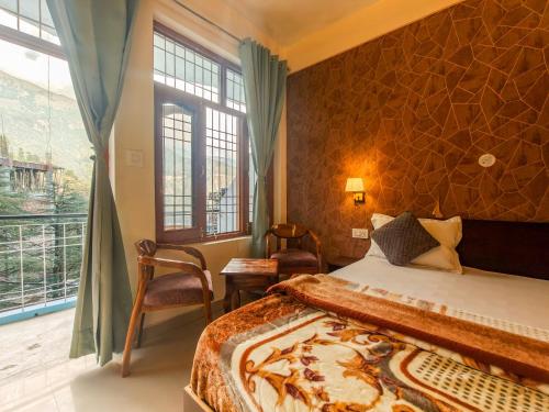a bedroom with a bed and a large window at Art-llers Homestay in Dharmsāla