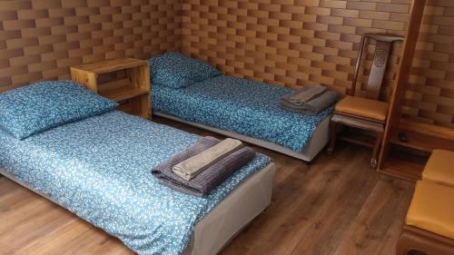 two twin beds in a room with a mirror at Chmurka in Górno
