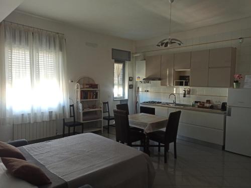 a kitchen and living room with a table and chairs at Marisella holidays house in Pozzuoli
