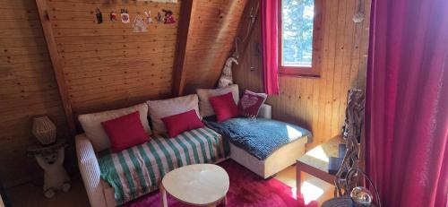 a room with a couch and a bed and a window at Chalet Fontaine 54 in Ustou