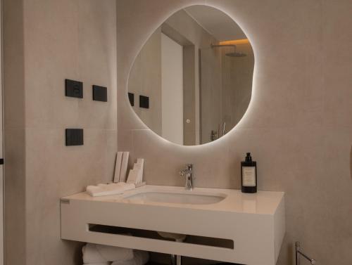 a bathroom with a sink and a mirror at la Réserve by Duka Winery in Draç