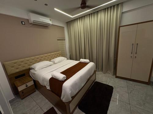 a bedroom with a large bed with towels on it at Mahadeva Residency in Trivandrum