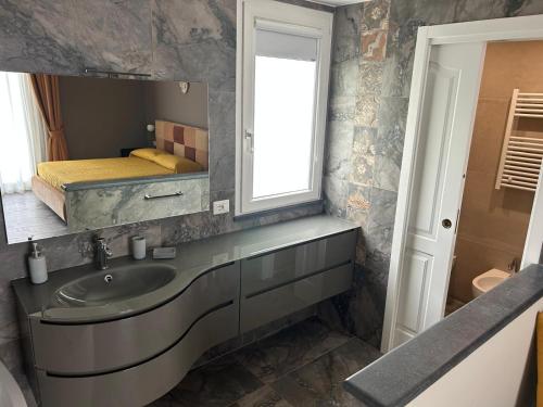 a bathroom with a sink and a mirror at Villa Iulia Hills in Fiumefreddo di Sicilia