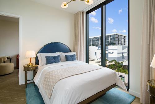 a bedroom with a bed and a large window at The 27 Wynwood in Miami