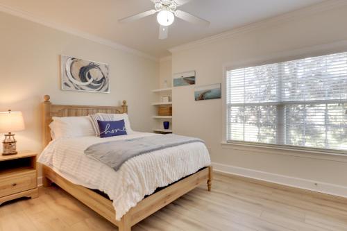 a bedroom with a bed and a window at Pool Access! Recently Updated Coastal Retreat in Foley