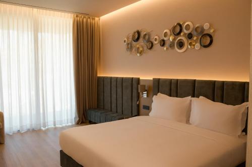 a bedroom with a large white bed with white pillows at la Réserve by Duka Winery in Draç