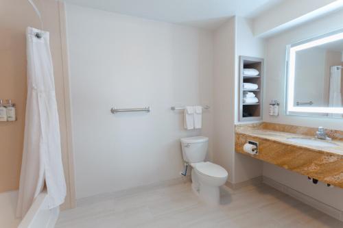 a bathroom with a toilet and a sink and a shower at Holiday Inn Express & Suites Logan by IHG in Logan