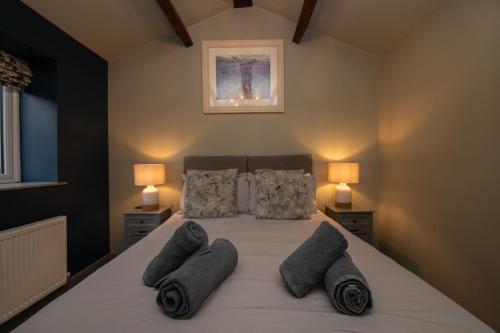 a bedroom with a large bed with pillows on it at The Lookout Holmfirth in Holmfirth