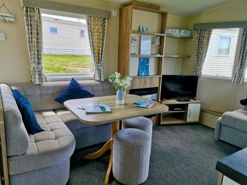 a living room with a table and a couch at Newquay Bay Resort pet friendly sleeps 6 WiFi in Newquay