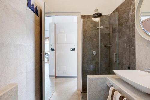 a bathroom with a shower and a sink and a mirror at Juliet in Levanto