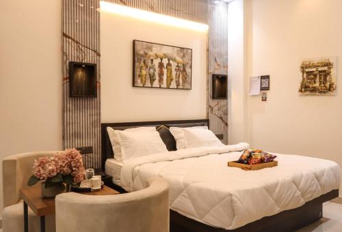 a bedroom with a bed and a table with a chair at The Glam By Sandane Homes in Greater Noida