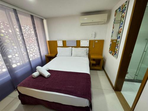 a bedroom with a large bed in a room at HOTElES SAN ANTONIO in Cali