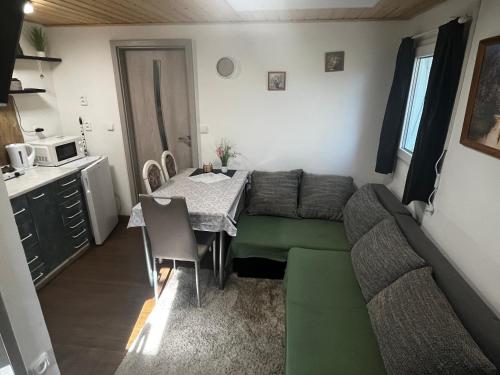 a living room with a couch and a table at Chatička u Perniců in Jedovnice