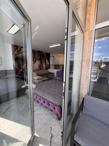 a room with a purple mattress in a room at Apartman CITY CENTER 9 BAZEN in Prijedor