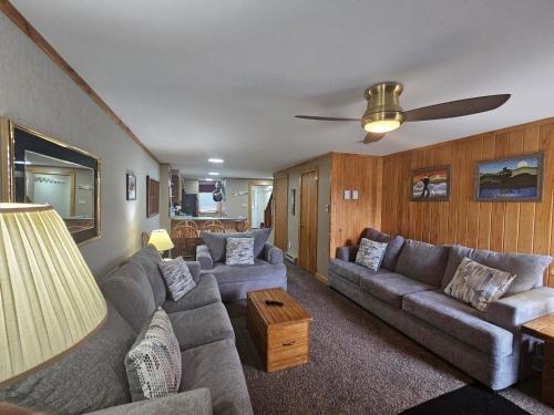 a living room with couches and a ceiling fan at Powderidge 42 2 Br: Sleeps 10 in Snowshoe
