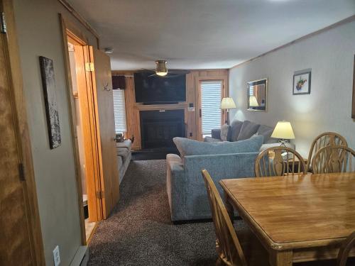 a living room with a blue couch and a table at Powderidge 42 2 Br: Sleeps 10 in Snowshoe