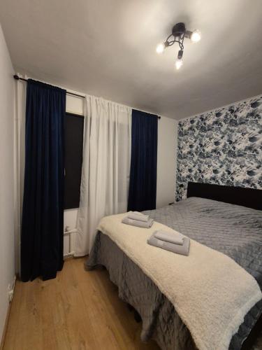 a bedroom with a bed with two towels on it at Azure Nordic Retreat in Rauma