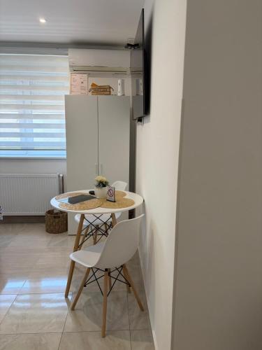 a small kitchen with a table and chairs in a room at Apartman Diamond LUX in Surčin