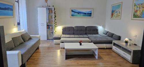a living room with a couch and a table at Artist Apartment in Keszthely