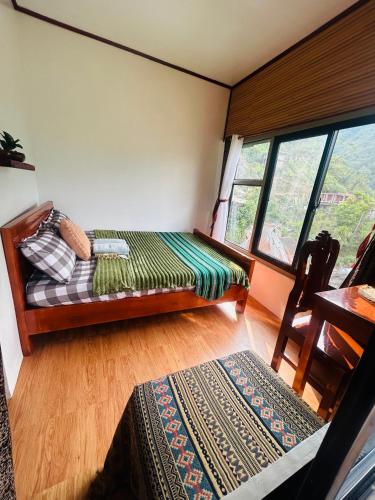 a room with a bed and a window at Batad Pension Ph in Banaue