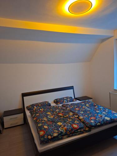 a bedroom with a bed with a yellow ceiling at Ferienwohnung Egbert in Weißwasser