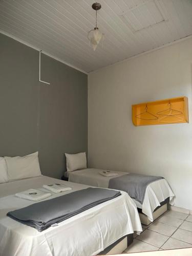 a room with two beds in a room at Hotel Castro Alves, São Paulo in São Paulo