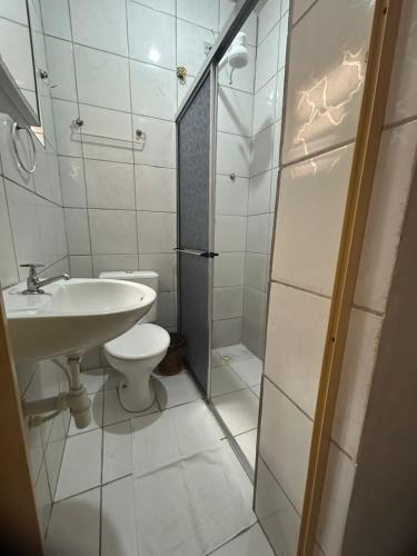 a white bathroom with a sink and a toilet at Hotel Castro Alves, São Paulo in São Paulo