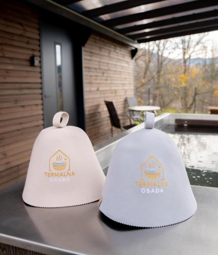 two white hats sitting on top of a table at Termalna Osada in Brenna