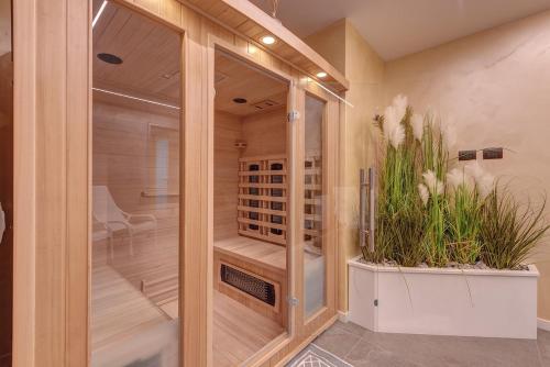 a walk in shower with two plants in a room at Villa Orchidea in Onno