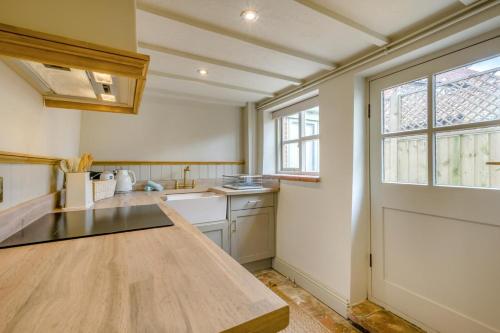 a kitchen with a counter top and a window at 1 Bed in Holt oc-p34797 in Holt