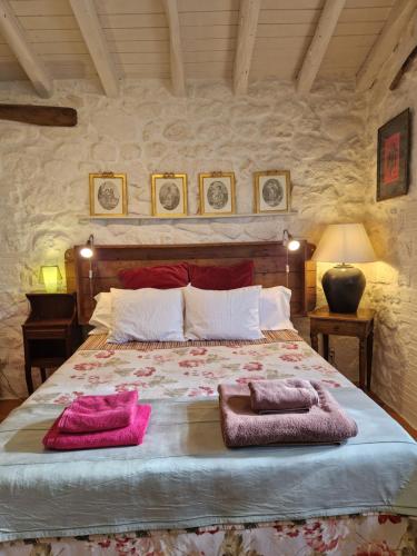 a bedroom with a large bed with two towels on it at El Atalanto in Madrigal de la Vera