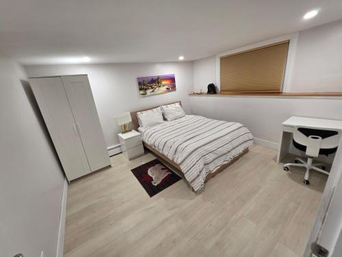a small bedroom with a bed and a desk at Garden City-Private 1BR Full Apt in Halifax