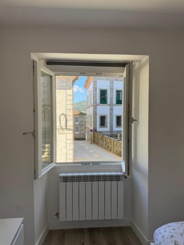 a window in a white room with a radiator at Cabalo Holiday Inn in Tui