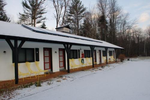 a building with yellow chairs in the snow at Gore Mountain Lodge in North Creek