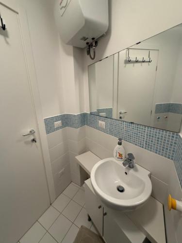 a white bathroom with a sink and a mirror at Bella Trinacria in Aragona