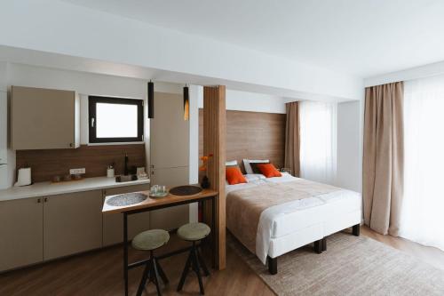 a hotel room with a bed and a kitchen at Gate67 in Otopeni