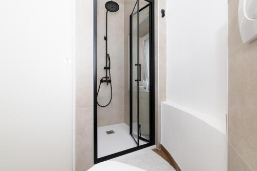 a bathroom with a shower with a large mirror at Amare in Mali Lošinj