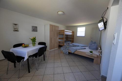 a bedroom with a bed and a table and chairs at Ferienpark Buntspecht Apartment A in Pruchten
