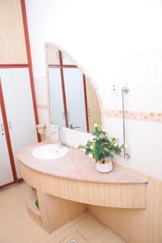 a bathroom with a sink and a mirror at Sehrai Royal Villa in Multan
