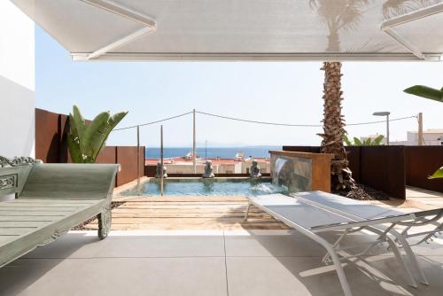 a villa with a pool and a patio with a table at Vista Roses Mar - Ancla Mar in Roses